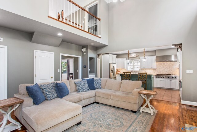 kitchen with stainless steel appliances, white cabinets, light tile patterned floors, and light stone counters