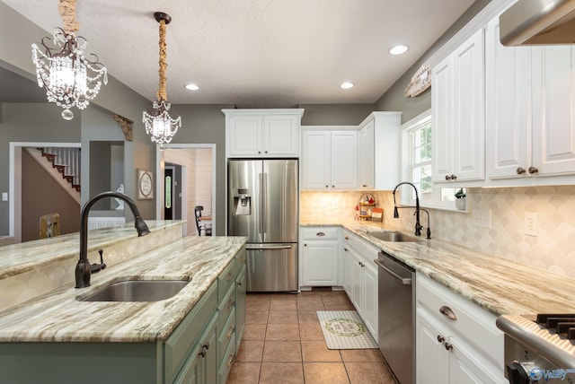 kitchen with sink, white cabinetry, appliances with stainless steel finishes, and pendant lighting