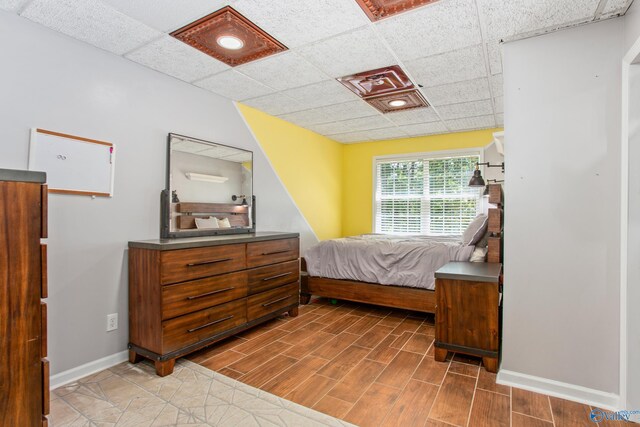 tiled living room featuring a paneled ceiling