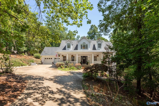 cape cod-style house with a garage and a porch