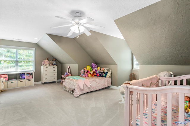 bedroom featuring vaulted ceiling, ceiling fan, a textured ceiling, and light colored carpet