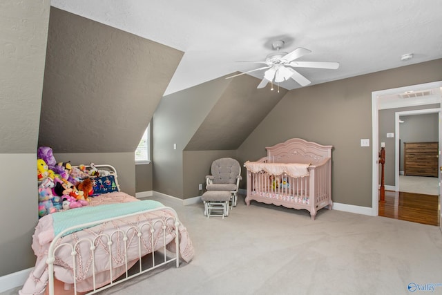 carpeted bedroom with ceiling fan and lofted ceiling