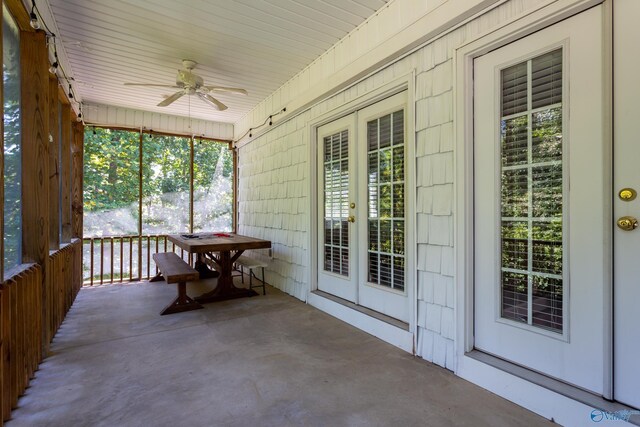 unfurnished sunroom featuring ceiling fan