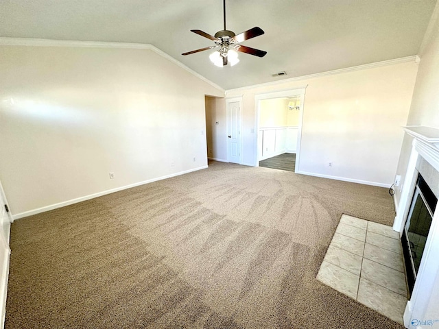 unfurnished living room featuring ceiling fan, crown molding, lofted ceiling, a fireplace, and carpet