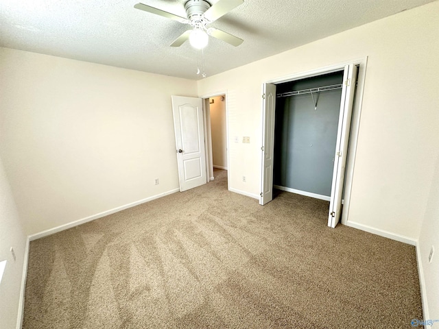 unfurnished bedroom with carpet flooring, ceiling fan, a closet, and a textured ceiling