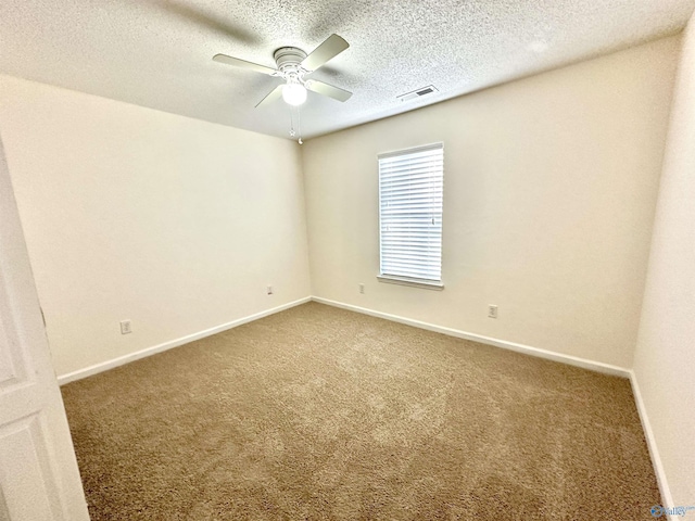 empty room with ceiling fan, carpet, and a textured ceiling