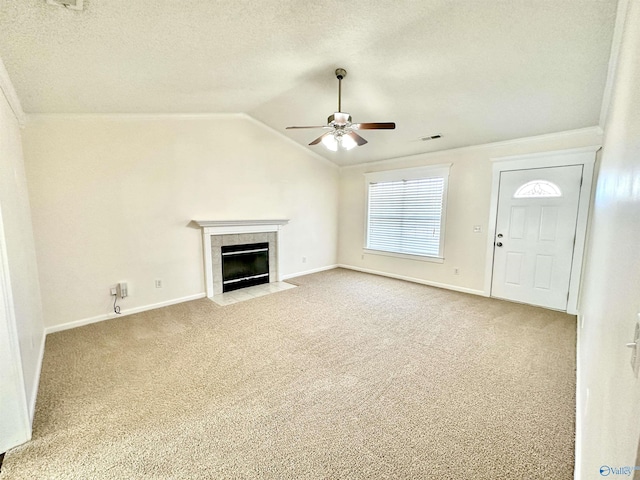 unfurnished living room featuring light carpet, vaulted ceiling, ceiling fan, a textured ceiling, and a fireplace