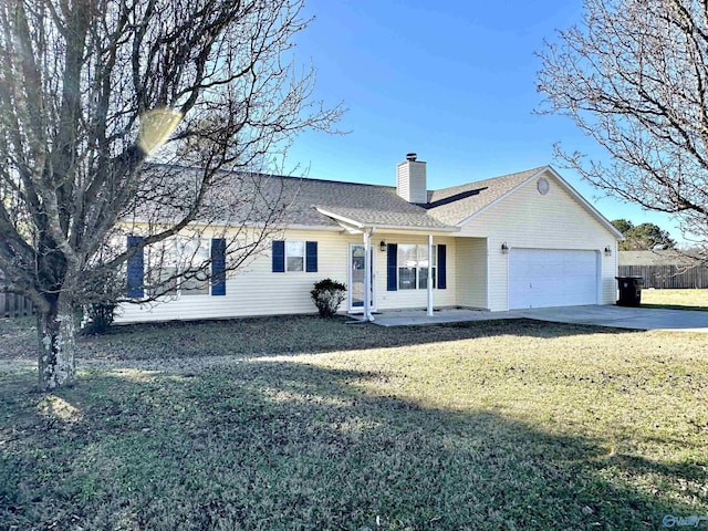 view of front of home with a front yard and a garage