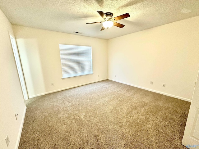 unfurnished room with carpet flooring, ceiling fan, and a textured ceiling