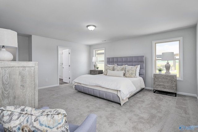 carpeted bedroom featuring baseboards