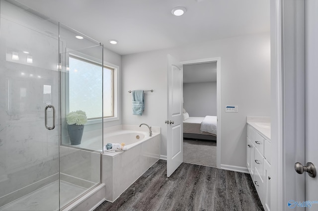 bathroom featuring vanity, shower with separate bathtub, and hardwood / wood-style flooring