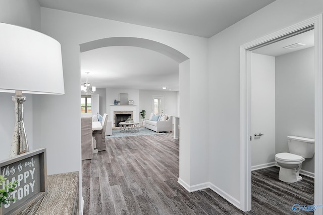 hallway with hardwood / wood-style floors