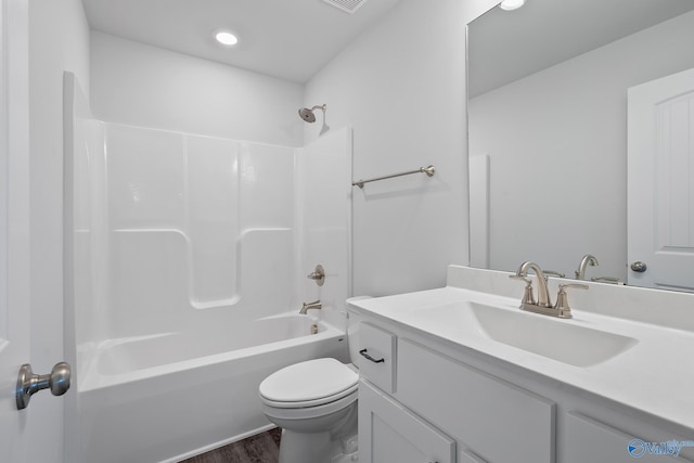 bathroom with shower / tub combination, toilet, wood finished floors, visible vents, and vanity