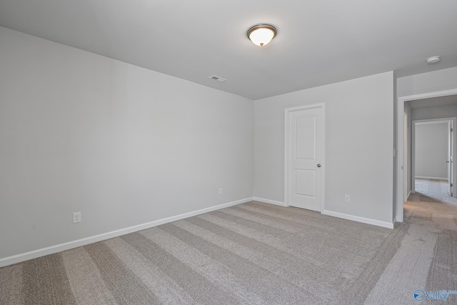 unfurnished bedroom featuring visible vents, baseboards, and light colored carpet