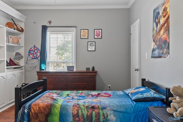 bedroom with ornamental molding and hardwood / wood-style floors