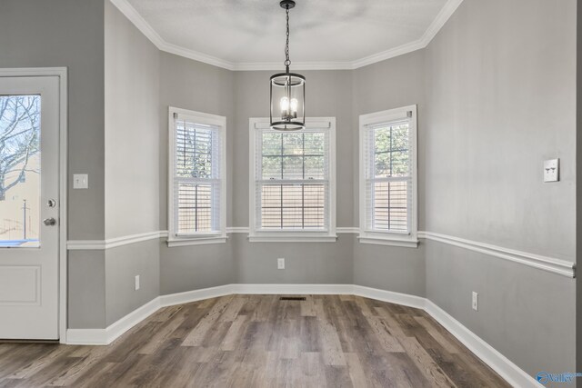 hallway with a textured ceiling, ornamental molding, and dark hardwood / wood-style floors