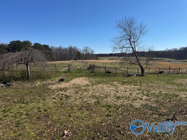 view of yard featuring fence and a rural view