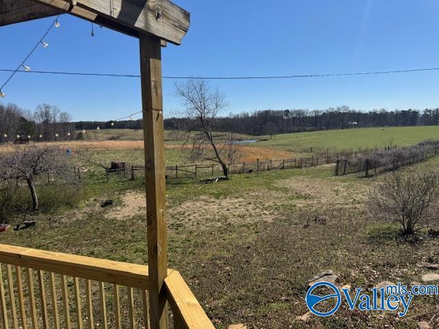 view of yard with a rural view and fence