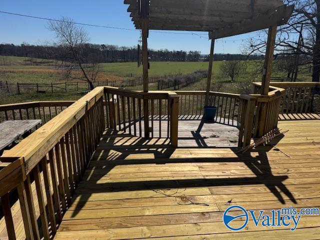 deck featuring a rural view and fence