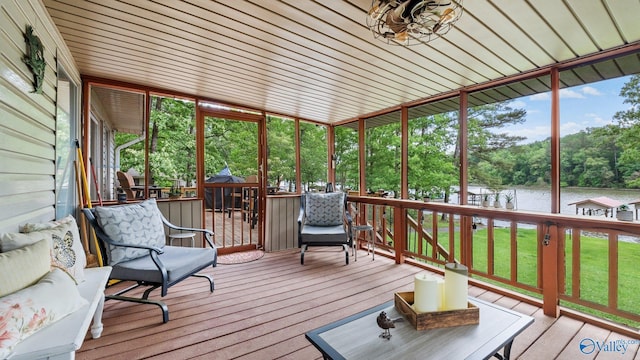 sunroom / solarium featuring a wealth of natural light and a water view