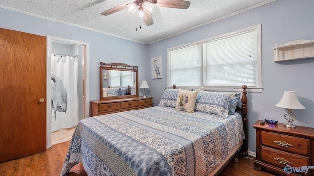bedroom with a ceiling fan, ornamental molding, a textured ceiling, and wood finished floors