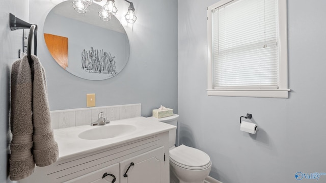 bathroom with toilet and vanity