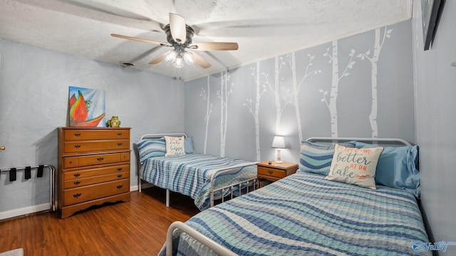 bedroom featuring a textured ceiling, wood finished floors, and ceiling fan