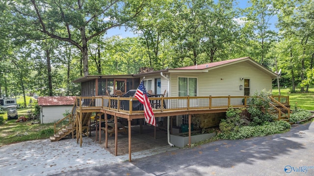 rear view of property with stairs and a wooden deck