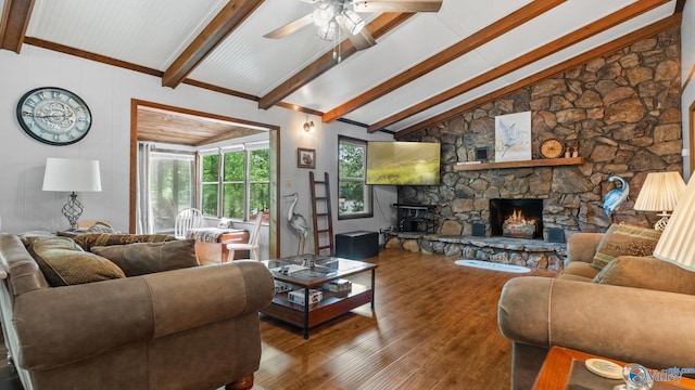 living area with a fireplace, ceiling fan, vaulted ceiling with beams, and wood finished floors