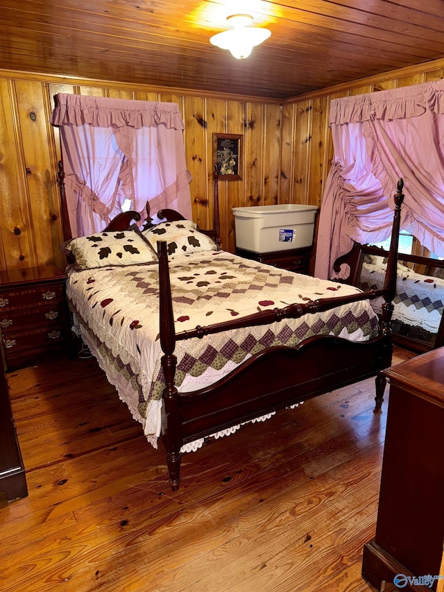 bedroom featuring wood walls, wood ceiling, and wood finished floors