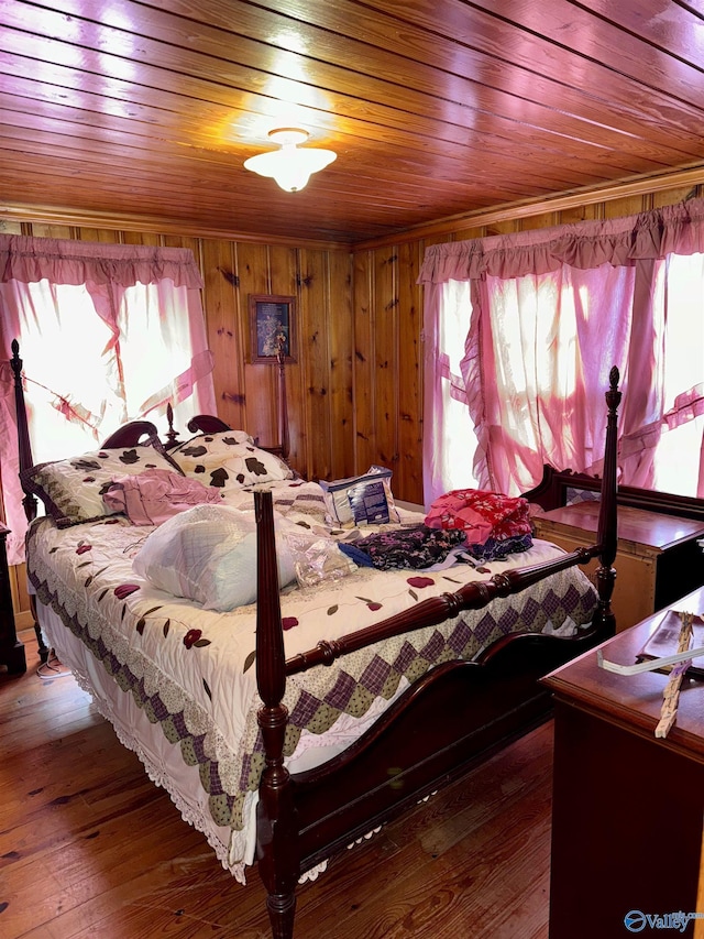 bedroom with dark wood-style floors, wooden ceiling, and wooden walls