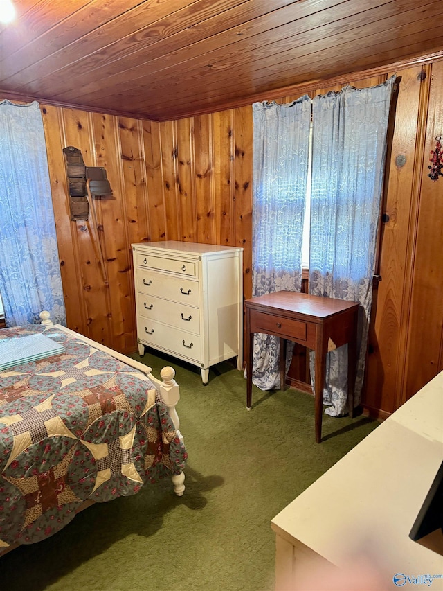 bedroom with dark carpet, wood walls, and wooden ceiling