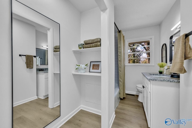 full bathroom featuring vanity, wood-type flooring, toilet, and shower / bath combo with shower curtain