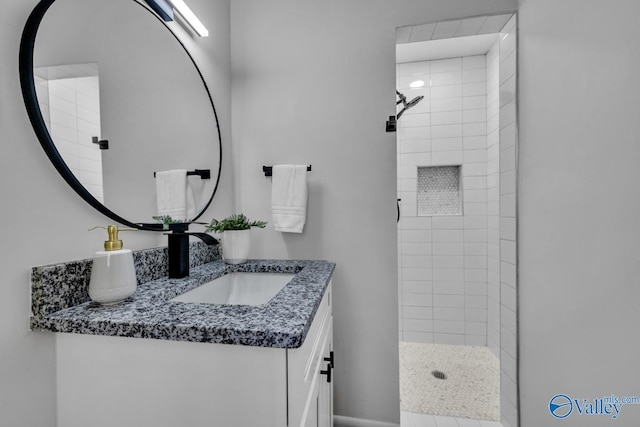 bathroom featuring vanity and a tile shower