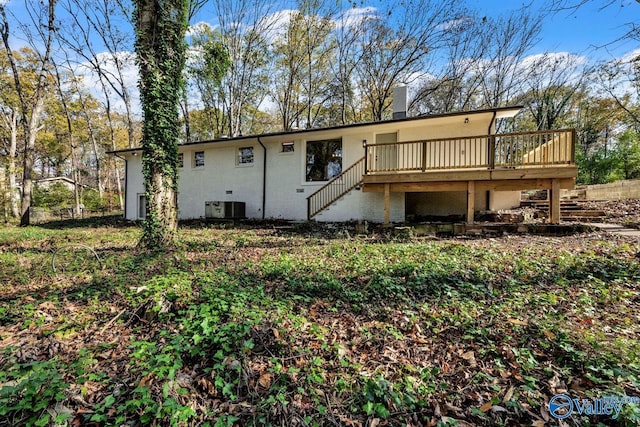 rear view of house featuring a wooden deck and central air condition unit