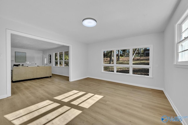 unfurnished living room featuring light wood-type flooring