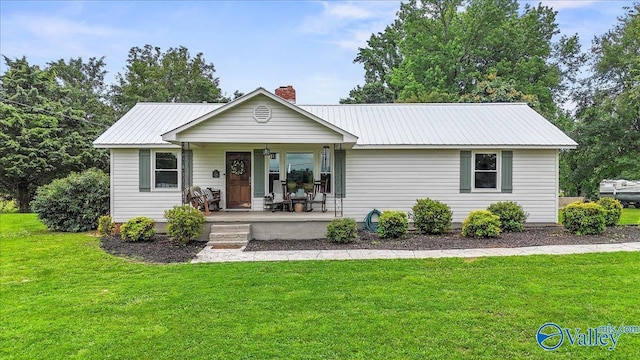 1760 Horseshoe Bend Rd, Scottsboro, AL 35769 - ranch-style house with covered porch, a chimney, a front lawn, and a metal roof
