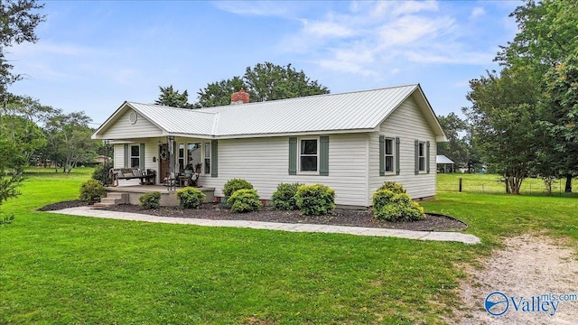 1760 Horseshoe Bend Rd, Scottsboro, AL 35769 - ranch-style house featuring a front yard, a chimney, a metal roof, and covered porch