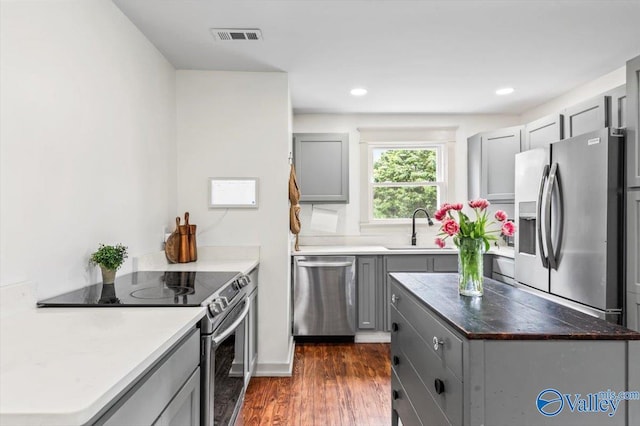 1760 Horseshoe Bend Rd, Scottsboro, AL 35769 - kitchen featuring stainless steel appliances, gray cabinetry, dark wood finished floors, a center island, and recessed lighting