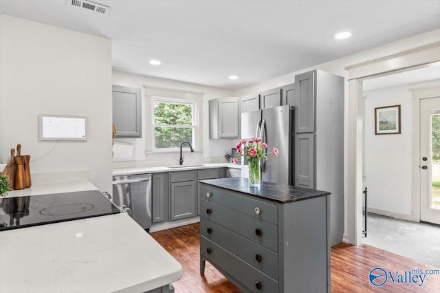 1760 Horseshoe Bend Rd, Scottsboro, AL 35769 - kitchen with stainless steel appliances, gray cabinets, wood finished floors, a center island, and recessed lighting