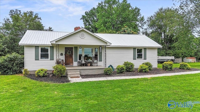 1760 Horseshoe Bend Rd, Scottsboro, AL 35769 - ranch-style house featuring a porch, a chimney, a front lawn, and a metal roof