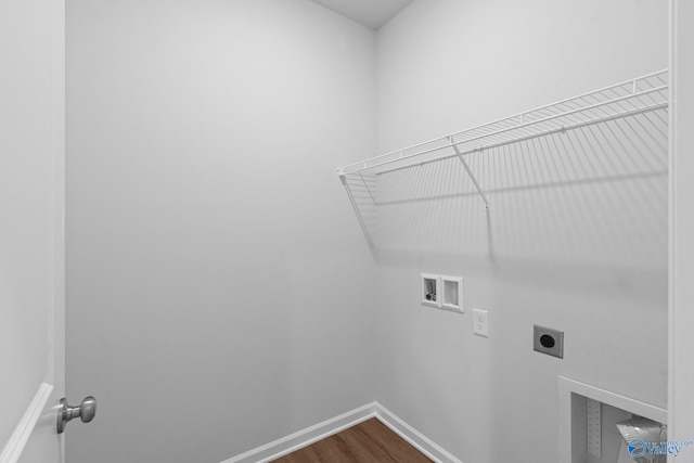 washroom featuring laundry area, electric dryer hookup, washer hookup, dark wood-style flooring, and baseboards
