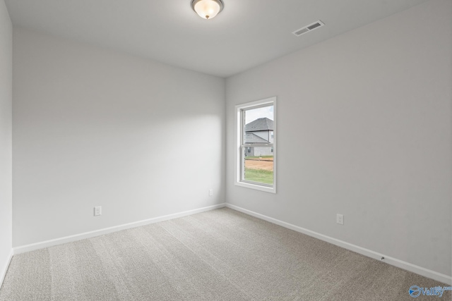 unfurnished room featuring visible vents, baseboards, and carpet floors