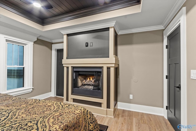 bedroom featuring a raised ceiling, crown molding, wood ceiling, and light hardwood / wood-style floors