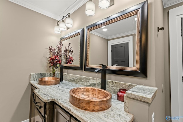 bathroom with crown molding and vanity