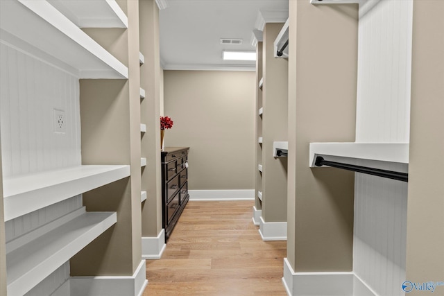 spacious closet featuring light hardwood / wood-style flooring