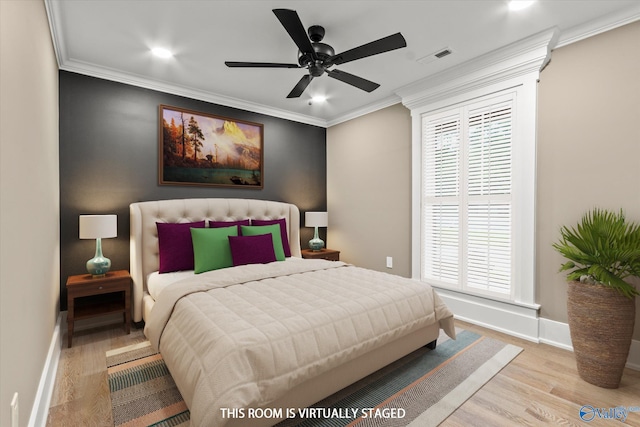 bedroom featuring ceiling fan, ornamental molding, and light hardwood / wood-style flooring