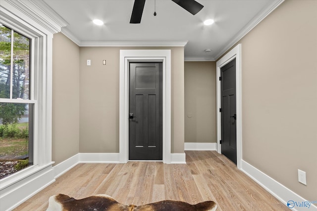 entryway featuring ceiling fan, ornamental molding, and light hardwood / wood-style flooring