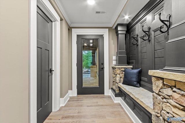 mudroom with ornamental molding and light hardwood / wood-style flooring