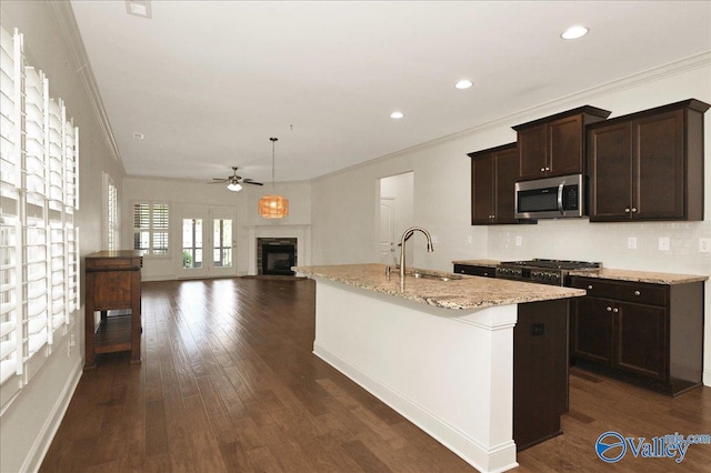 5 Leyland Dr, Huntsville, AL 35824 - kitchen featuring stainless steel microwave, a sink, ornamental molding, ceiling fan, and a fireplace